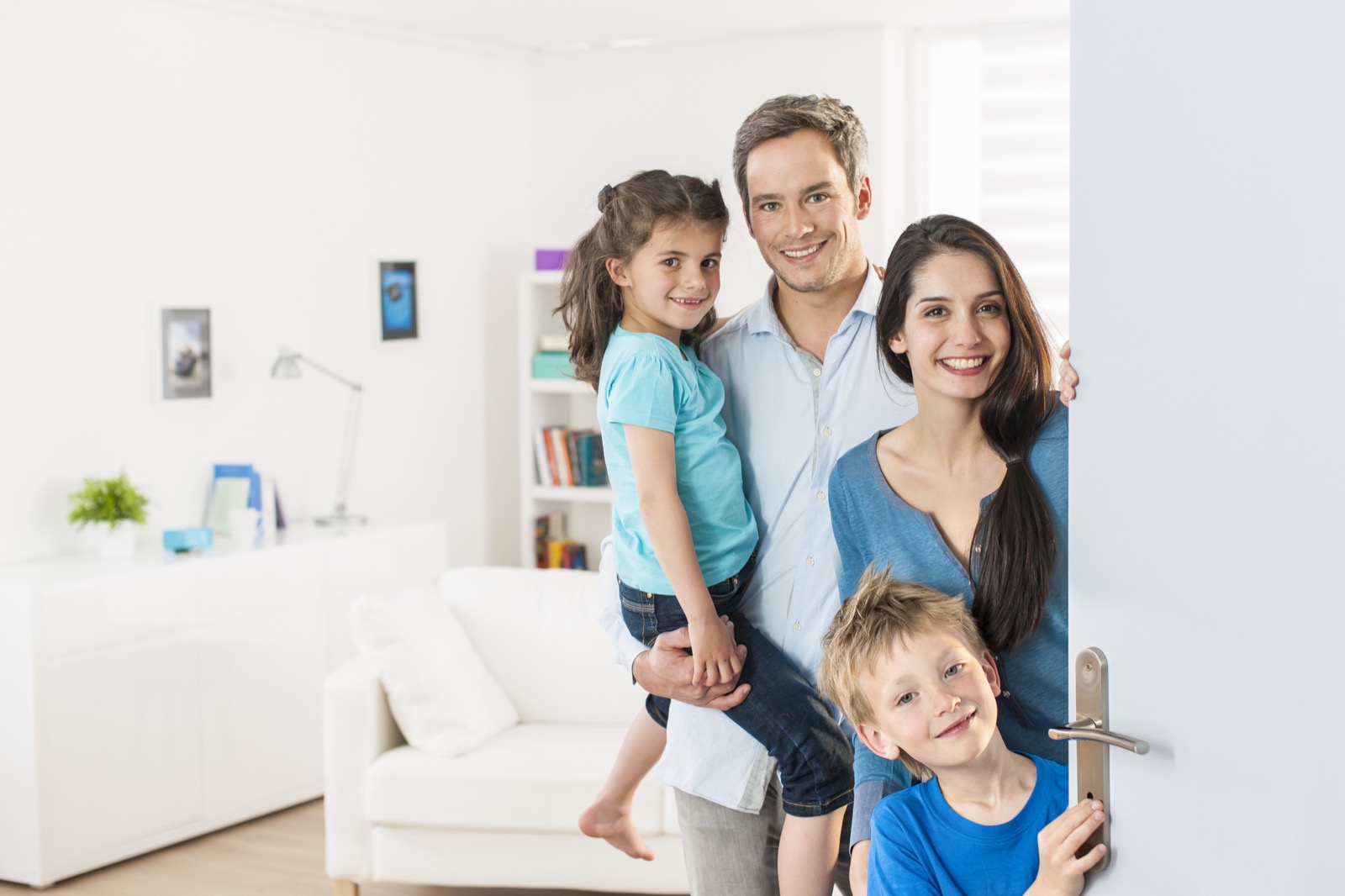 Happy family welcoming a technician into their comfortable home